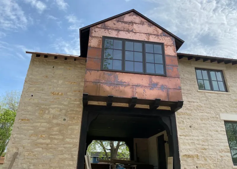 Copper metal panel facade on a stone building for Metal Roof Coating in Wake Forest