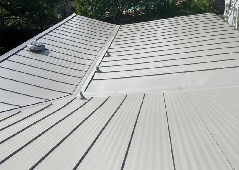 Solar attic fan installed on a metal roof for Roof Ventilation in Wake Forest